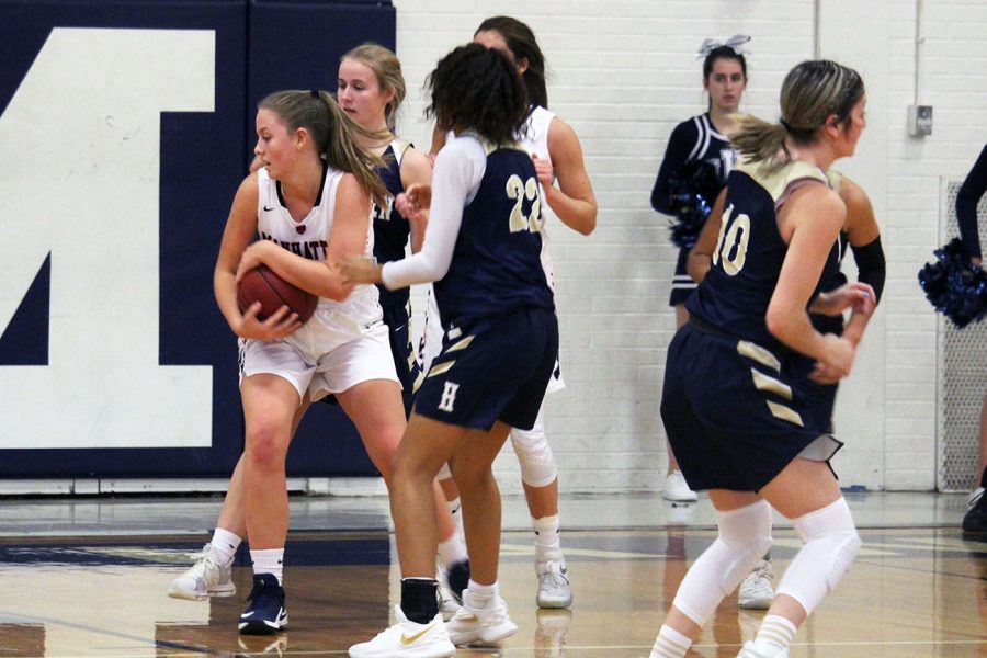 Junior Alorea Osterman protects that ball before passing it to a teammate during the MHS varsity girls basketball game on Dec. 14. Photo by Jennifer Sadler