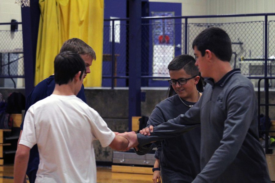 Freshmen Connor Bruce, Paul Batt, Evan Bratt and Cade Mcilbaine square dance during freshman P.E. The freshman have been learning and practicing square dancing for the past two weeks. Photo by Javi Mercado