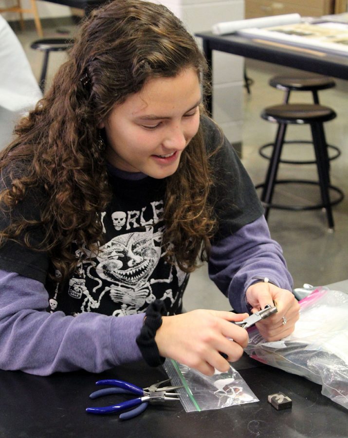 Junior Abbey Shaneyfelt as she works on her newest art piece.