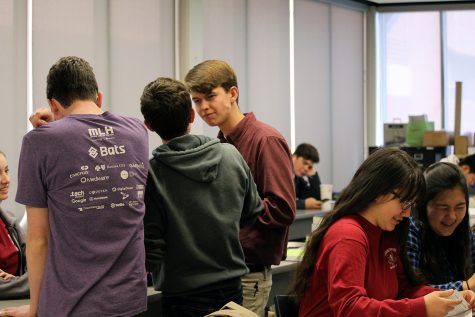 Senior Seth Higgons, Anna Mackey, juniors Alexis Gray and other statistic students converse during spare time in their class. 