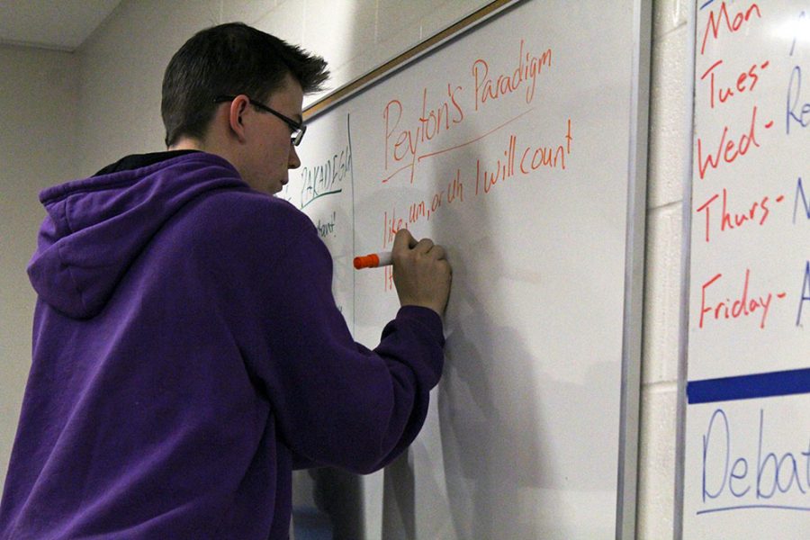 Junior Peyton Woods prepares his paradigm for a mock-competition after school.