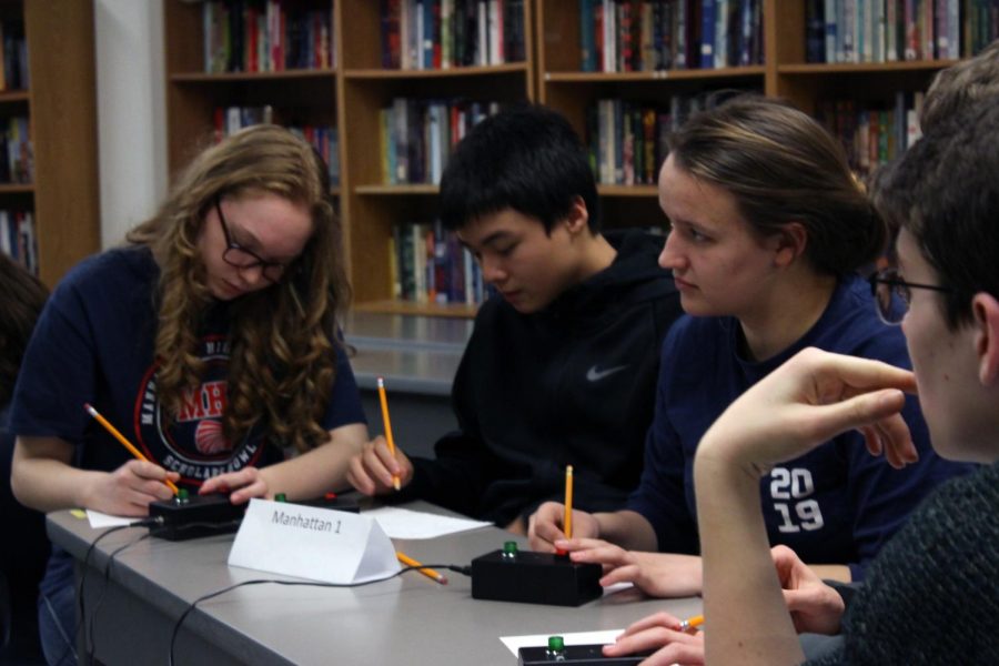 Freshman Rachael Kovar, Luke Liu, Ronan Tanona, and sophomore Nicole Savage compete against Rock Creek High School at a home tournament Jan. 28.