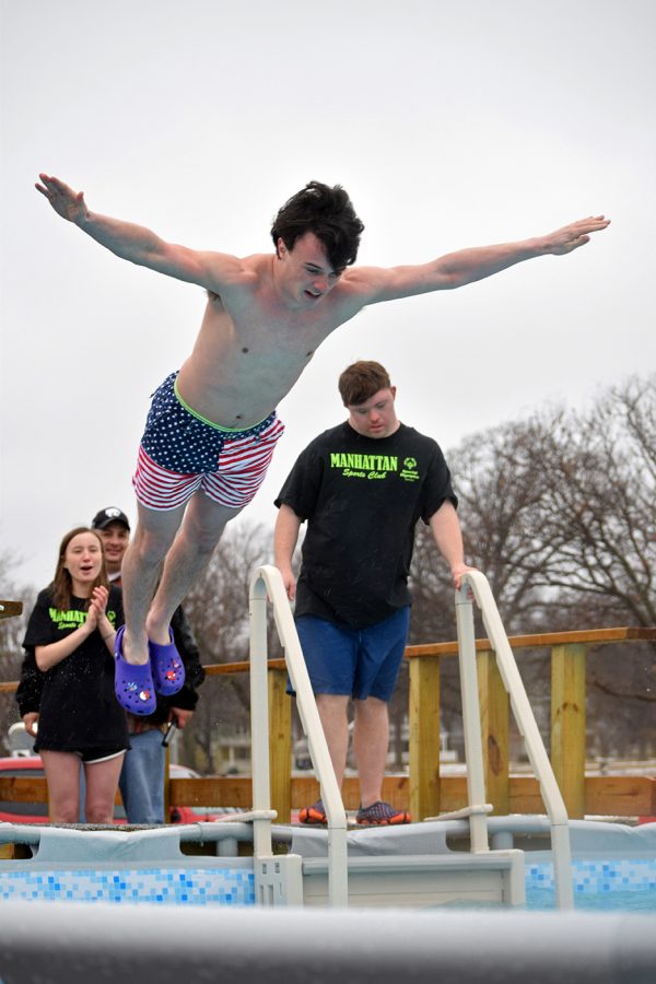 Senior Max Landsdowne belly flops into the ice-cold water during the polar plunge event on Feb. 23. Many MHS students participated in the plunge this year, the event raised money and awareness for the special olympics.