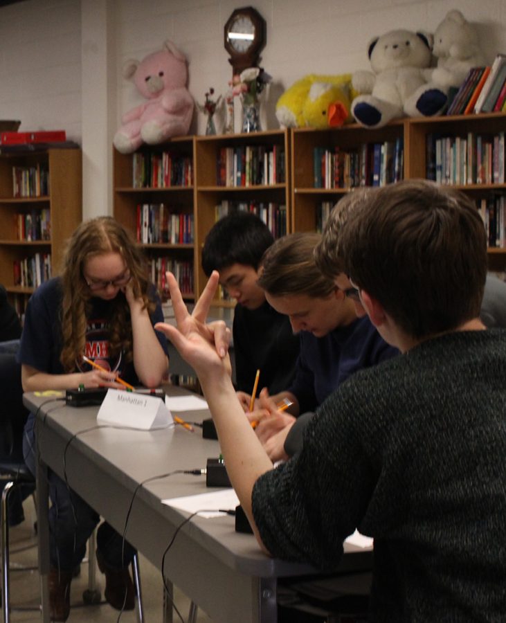 The MHS Scholars Bowl team works to complete a math question during the Scholars Bowl competition on Jan. 28. 