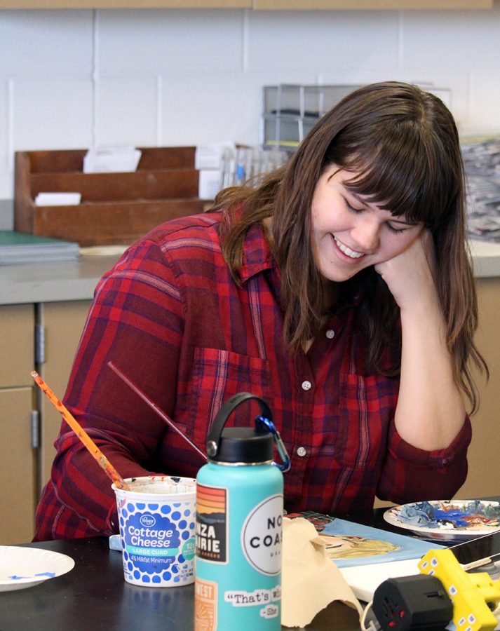 Senior Ashley Savage works on her painting. Savage won the high school divison award for the Martin Luther King Jr contest, this years theme was we may have all come on different ships, but we are on the same boat now. Savage has also previously won first place in Early Expressions for 2-D art. 