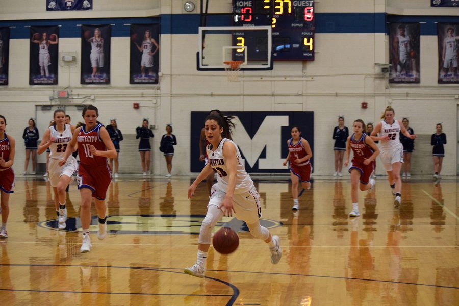 Senior Haileigh Harper dribbles down the court during the varsity sub-state basketball game. The Lady Indians won the game against Dodge City 54-36, their last home game of the year. 