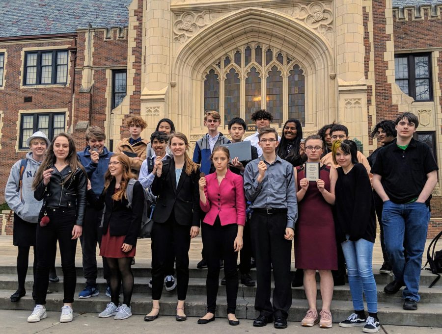 The Manhattan High Forensics team poses in front of Topeka High with their awards at their meet Saturday. The team took home another national qualification to make three total, as well as another state qualification to adorn their wall. Photo courtesy of 