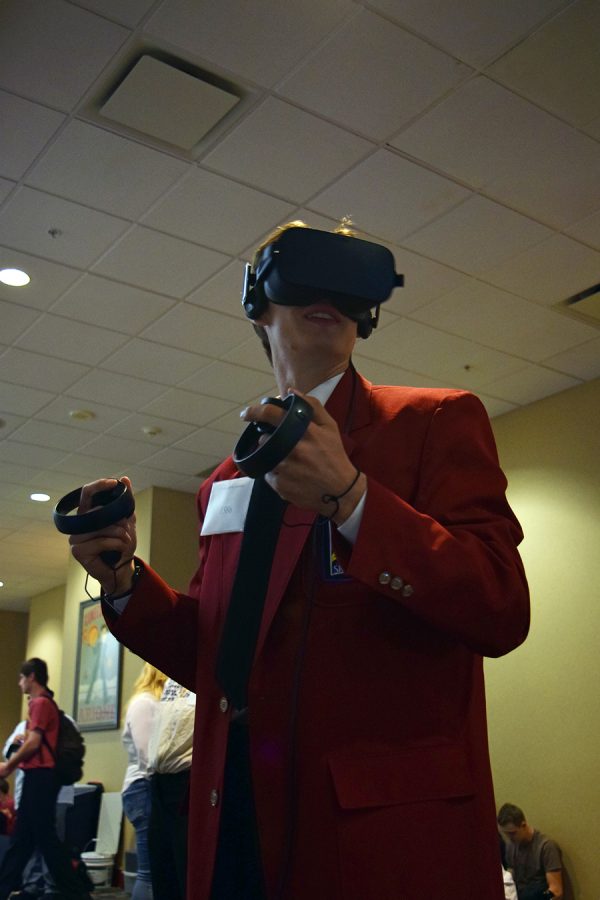 Senior Zach Payne plays on a virtual reality gaming system while waiting for his competition to begin at the Skills USA Kansas Championship. Six MHS students left for Hutchinson Kansas on April 23 to compete against other students, two of the six students took first place in their competitions with gold medals. 