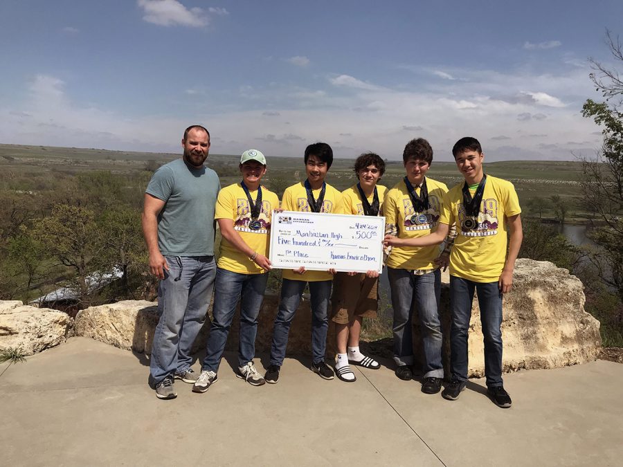 The+Manhattan+High+Envirothon+team+poses+at+Camp+Wood+with+their+first-place+prize.+