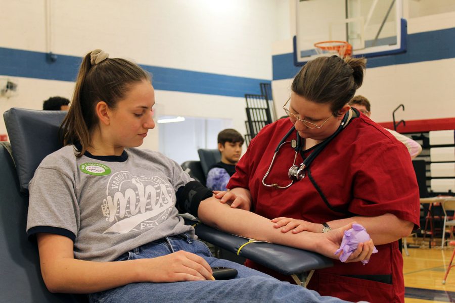 Junior+Krystal+Kilner+sits+back+in+her+chair+during+the+blood+drive+on+April+ninth.+After+giving+blood+the+donors+were+treated+to+oreos+and+other+iron-rich+snacks+to+replenish+themselves+with.+