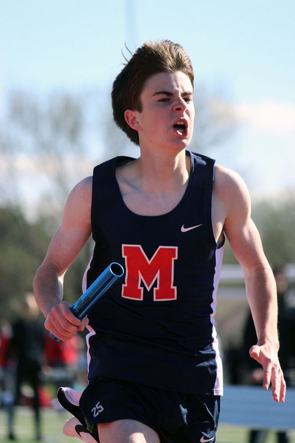 Freshman Ben Mosier carries the baton in the first leg of the 4 X 800m relay. 