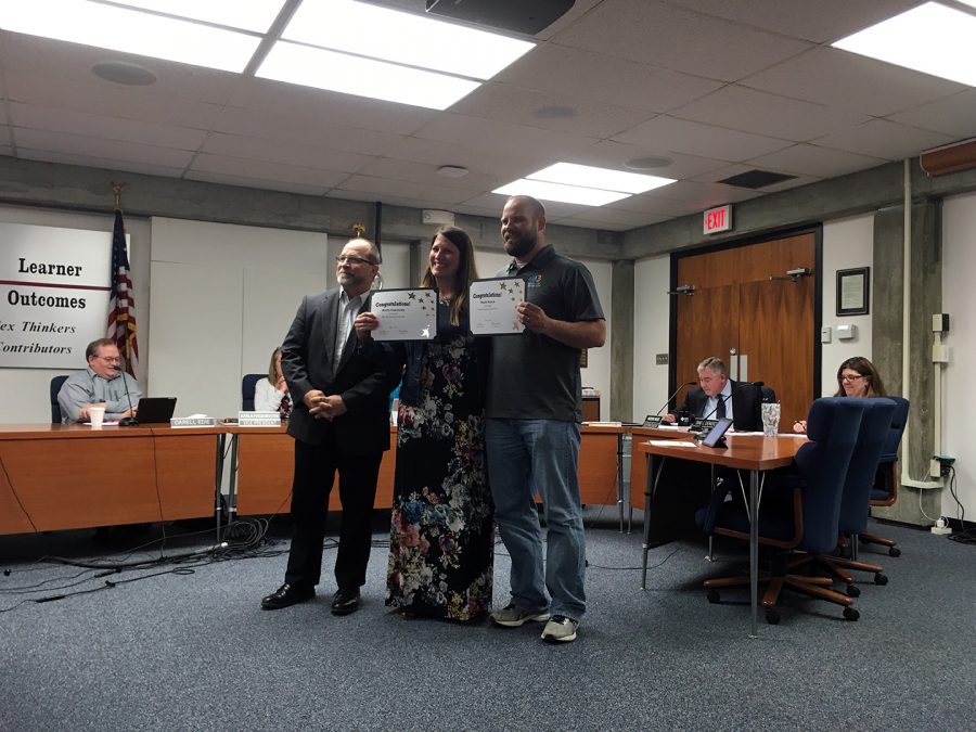 MHS+Teacher+Noah+Busch+holds+up+his+award+at+the+May+1+Board+of+Education+meeting.+Busch+is+a+freshmen+biology+teacher+and+was+recognized+with+the+USD383+teacher+of+the+year+award.+