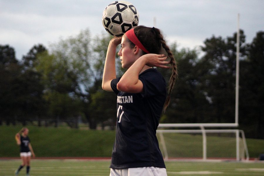 Junior+Alayna+Girard+gets+ready+to+throw+the+ball+in+from+the+sidelines+as+she+looks+for+someone+open+during+the+game+against+Shawnee+Heights+High+School+on+May+9th.+
