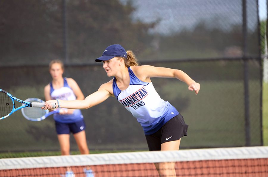 Senior Kate McGee passes the ball over the net during one of her doubles matches on Sept. 14. McGee played with freshman Maura Weins and they scored 1-3, ultimately taking eighth place. 