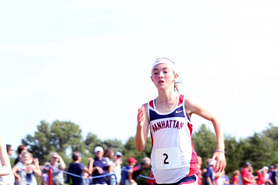 Freshman Amelia Knopp barrels toward the finish line, leading as Manhattans second runner. Knopp placed third with a time of 20:43.9, having ran a 5K at the Warner Park meet on September 7. 