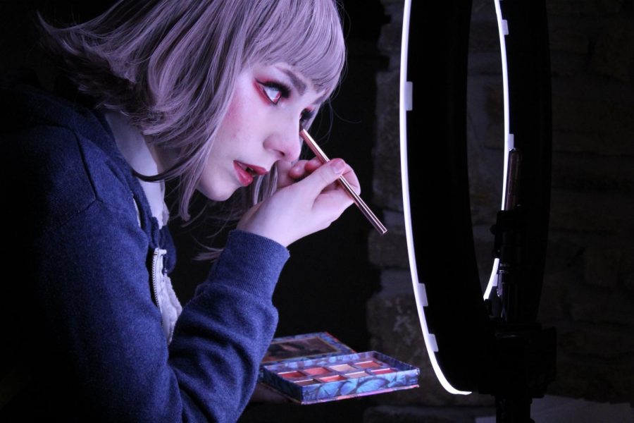 Junior Teagan Hitchings stands in front of a ring light while doing her eyeshadow for a cosplay. Hithcings uses her skills to gain followers on her TikTok account, which she says helps broaden her creativity.