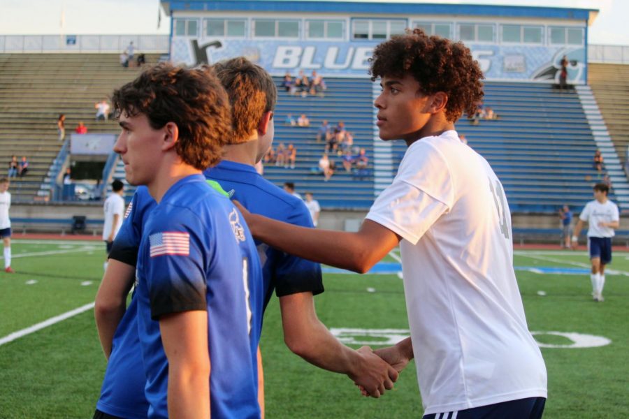 Junior Gabe Effiong shakes hands with Junction City team players. Effiong scored the seventh goal -- his first of his Varisty career -- on Thursday. Manhattan High beat J.C. 10-0 with 30 minutes till game.