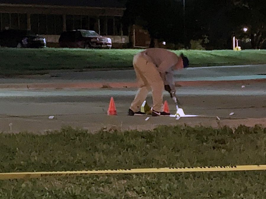 CSI searches the Oak Sreet parking lot of Mnahttan High for evidence where the crime happened the night of Sept. 12. 