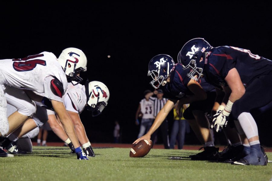 The Varsity football players line up to hike the ball to the quarterback. The boys won 56-24 on Sept. 20, the annual Homecoming game. 