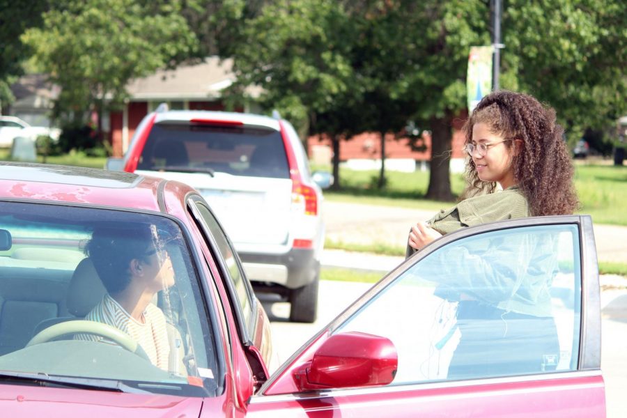 Seniors Roberto Maysonet Perez and Elise Mitchell converse in the Sunset Zoo lot after school on Monday. Both park in Sunset due to not having a parking pass and being late to school in the mornings. 
[I park here] because I dont want to pay 80 bucks for a parking pass, Maysonet Perez said. Im late too. 