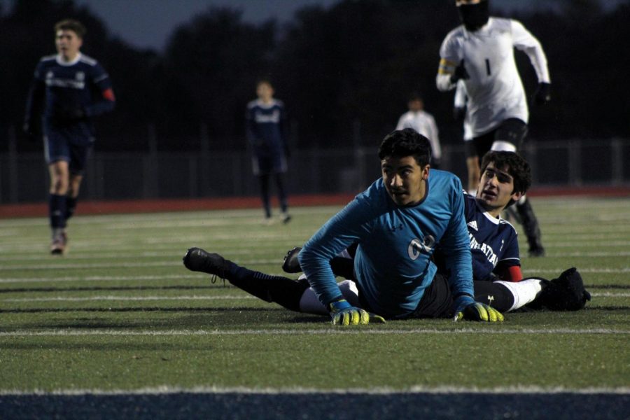 Senior Carter Wiens and the goalie from Haysville Campus watch as the ball rolls into the net, putting the first score of the night -- assited by Wiens and made by senior Hunter French -- on the scoreboard. The first Regionals game went 2-1 in favor of Manhattan on Oct. 29.