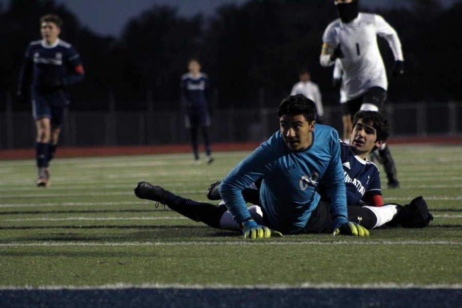 Senior Carter Wiens and the goalie from Haysville Campus watch as the ball rolls into the net, putting the first score of the night -- assited by Wiens and made by senior Hunter French -- on the scoreboard. The first Regionals game went 2-1 in favor of Manhattan on Oct. 29. 