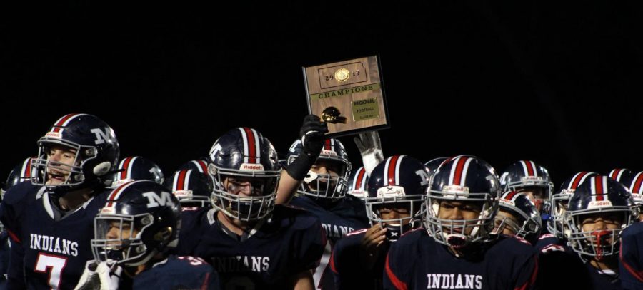 The Varisty football team holds up their Regional championship plaque after winning against Lawrence Free State, 49-28. The win determined the teams next game, which is at Derby on Nov. 16.
