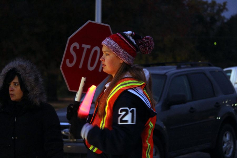 Junior Taylor Claussen hold the safety lights while participating in SADDs Red Ribbon Week. The week promoted healthy habits in MHS students, whether it be in things like drugs or every day actions. 