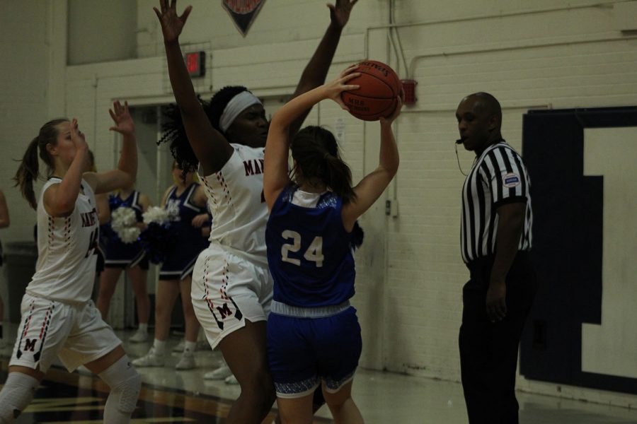 Senior Zanaa Cordis stands tall while defending a player from Washburn Rural. The game was played on Jan. 7 at MHS.