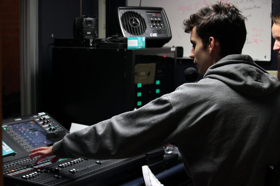 Senior Joshua Sapien checks the cast's mics to have them set and ready to go for their play, 'She Kills Monsters.' 