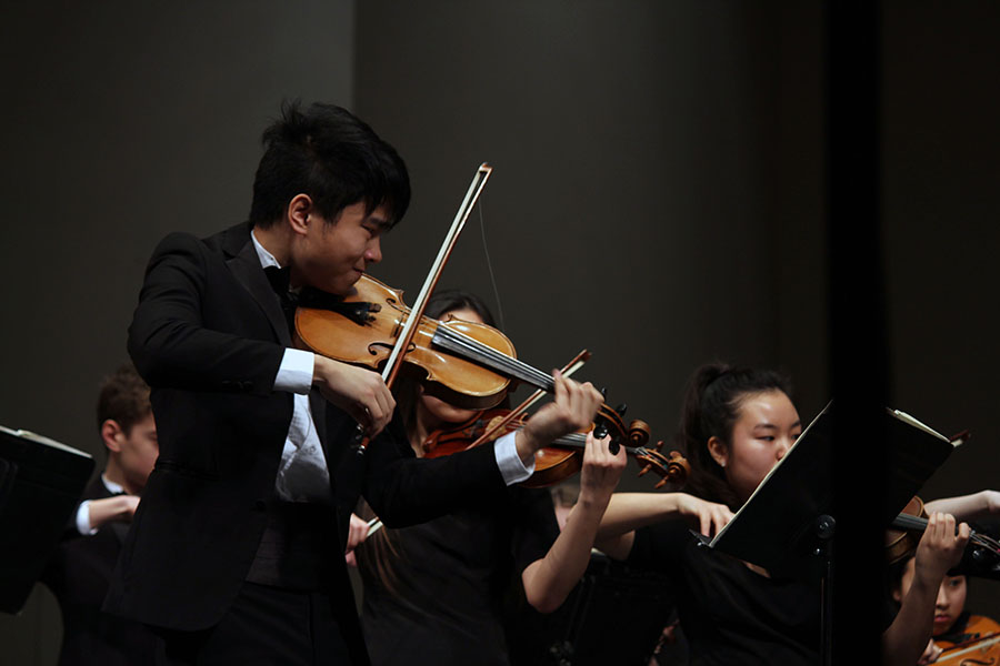 Senior Allen Zhang plays intensely to Shostakovichs String Quartet No. 8, which is meant to express both the sadness and anger he felt during the World War II era. His self-written requiem required that the Chamber Orchestra play aggressively, resulting in broken bow strings. 