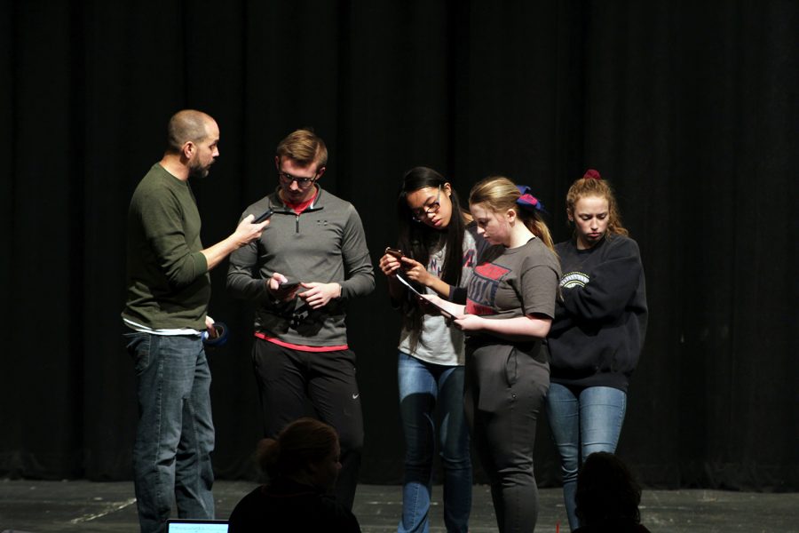 Paraeducator Chris Blanton helps out the emcees, seniors Aaron Hoff, Imary Ahorro, Jamia Roberts and Macy Hendricks.