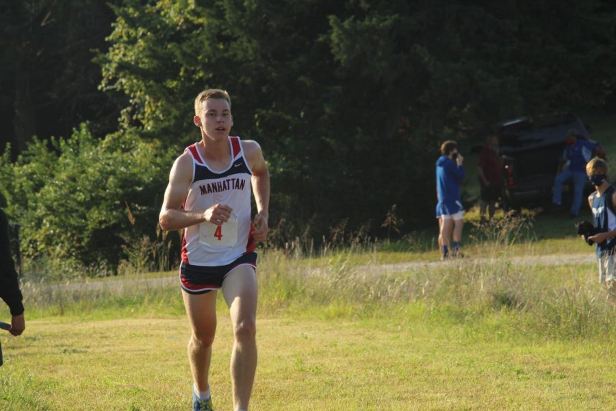 Cross Country runner Daniel Harkin runs the last quarter mile of the race at Warner Memorial Park in Manhattan. Harkin finished second individually and the team finished first.