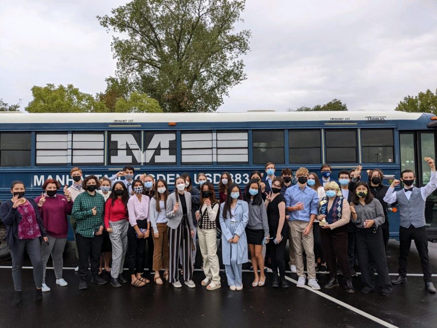 The Manhattan High Debate team lines up against their transportation bus. Overall, the team placed first at the USD 345 HS Fall Classic Debate Tournament. Photo by Carmello Streckfus