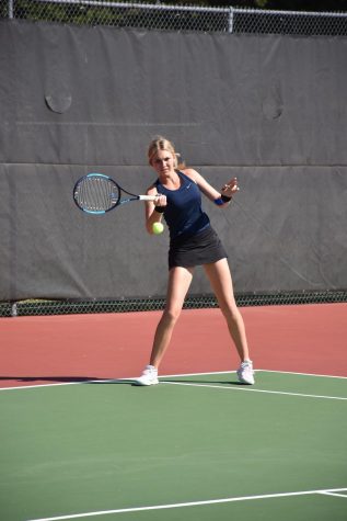 Junior Jillian Harkin sends the ball across the tennis court at State. Harkin won the 6A State Championship on Saturday. Photo courtesy of Gerald Wiens