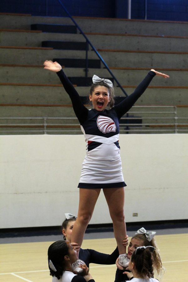 Junior Kaylee Kurman beams at the judges at the cheer showcase in Hays on Saturday. The MHS stunt group received Division I for their performance. Photo by Julianna Poe