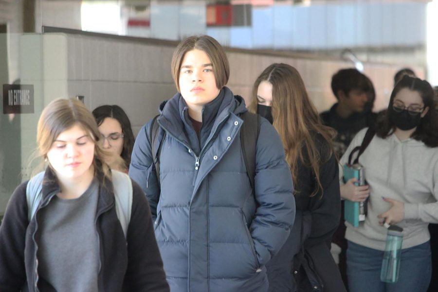 Sophomore Charles Keenan walks among other MHS students, some masked and some unmasked, after the mandate was lifted on Feb. 24.