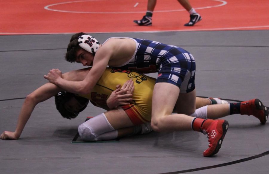 Logan+Lagerman+wrestles+his+opponent+in+the+third+place+match+on+Feb.+26.
