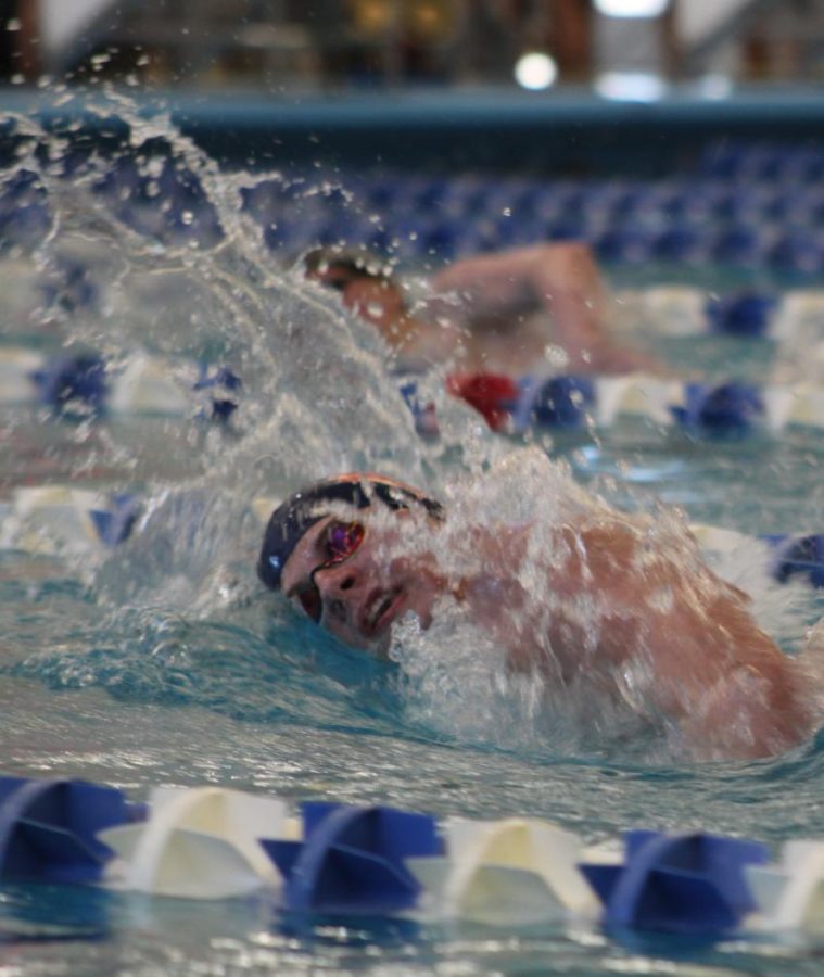 Junior Mitchell Burger swims for Manhattan High during the boys State tournament on Feb. 19 in Topeka.