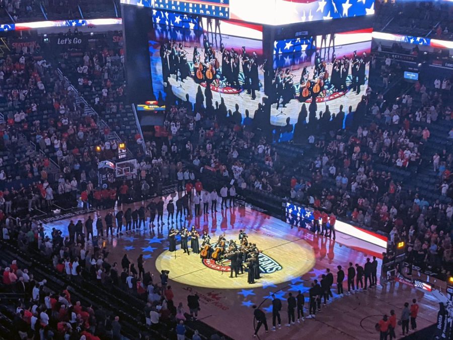 The Symphonic and Concert Orchestras performs The Star Spangled Banner at the Pelicans v. Spurs NBA game.