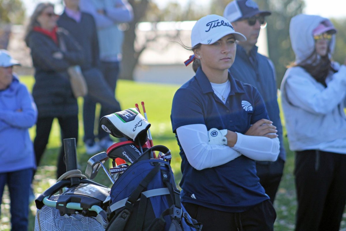 Excitement fills the air as Oct. 20, 2025, marks a pivotal day for Manhattan High School's girls varsity golf team. Early that morning in Hesston, Kansas, senior Kat Ball stands poised and ready, eagerly awaiting her turn to tee off in the state competition.