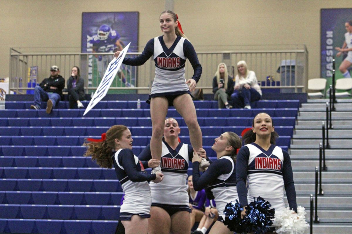 Rise and shine, cheer fans. On the early morning of Nov. 1, 2025 in Topeka, Kansas, Manhattan High School's Varsity Cheer team took part in an exciting cheer competition at Washburn Rural. The team proudly showcased their featured routine, lifting Junior Emma Wehling high above the crowd, just like they do during football games.
