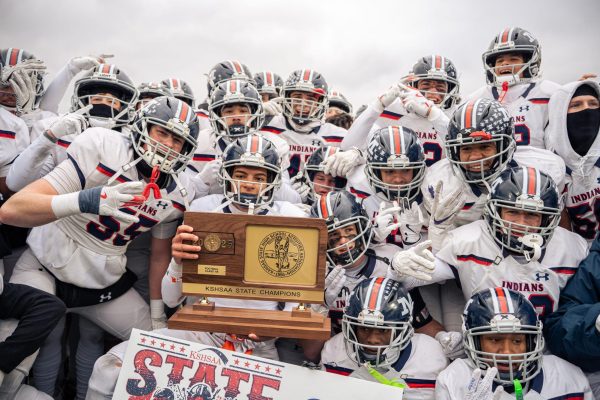 Manhattan High School players raise the KSHSAA State Champions plaque in triumph after securing the Class 6A football title. The team finished their season with the hardware after defeating Olathe Northwest in the championship game. Emporia, KS, Nov. 29.
