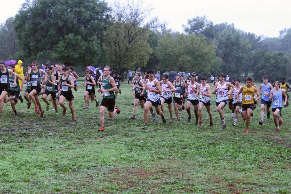 Go Patric! Patric Husher sprints forward and friend family and teammates cheer on the team. Patric helped Manhattan place first at regionals and qualify for state.