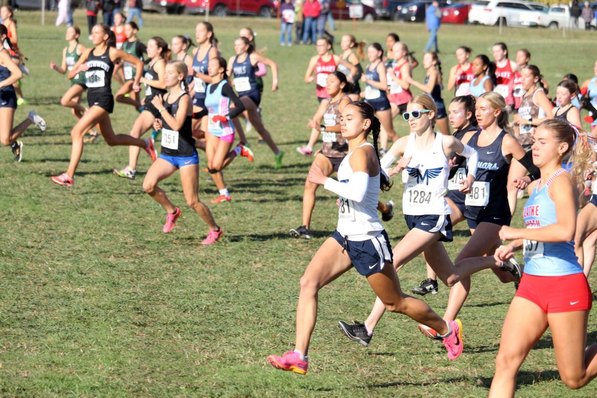 Go Gabie! Junior Gabrielle Converse sprints forward in front of the pack at the start of the race. Gabie placed 3rd leading Manhattan to become State Champions for the first time in 10 years. 