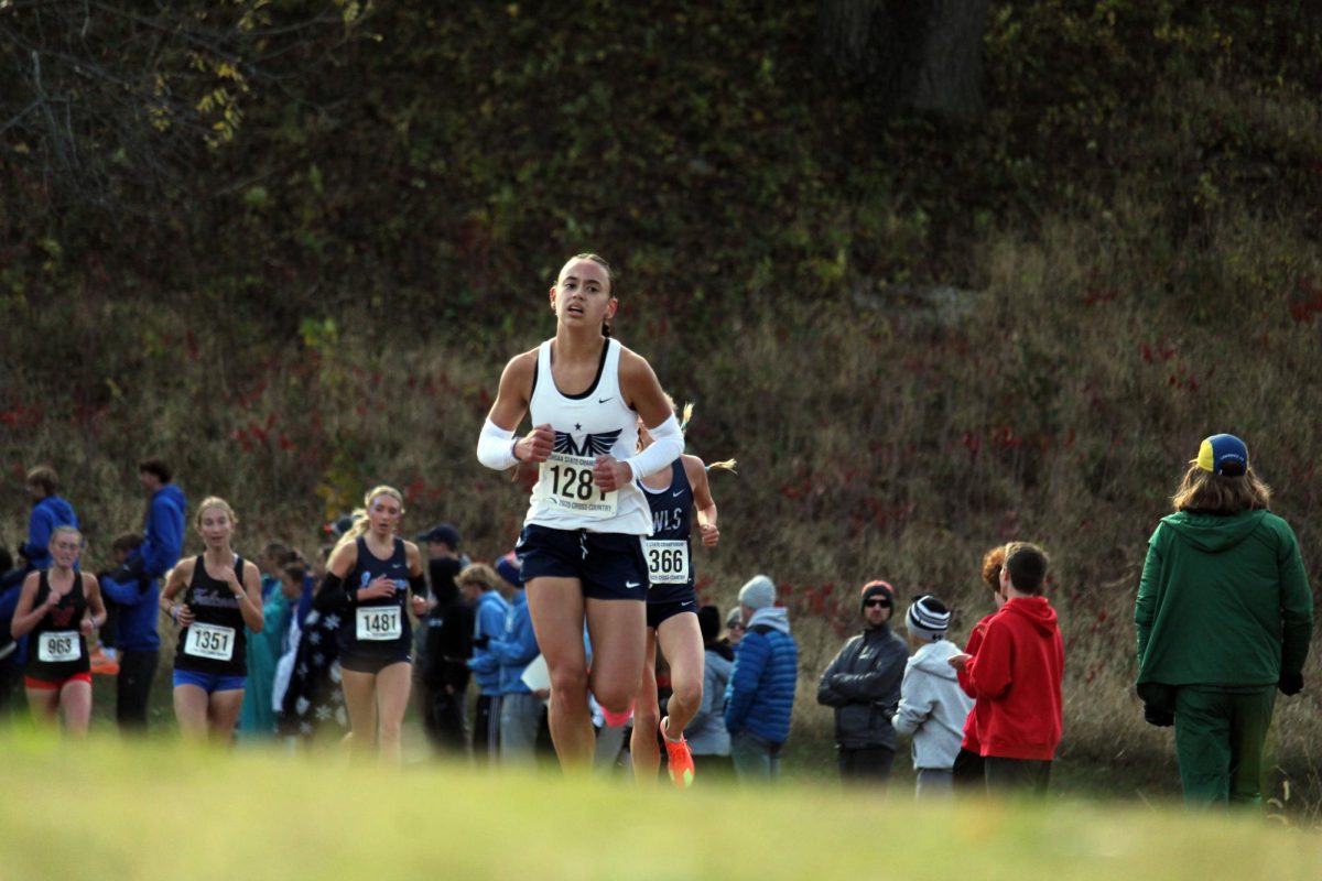 Go Gabie! Junior Gabrielle Converse sprints forward in front of the pack. Gabie placed 3rd leading Manhattan to become State Champions for the first time in 10 years. 