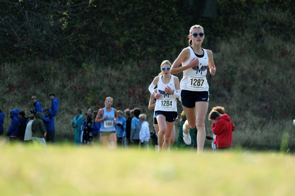 Go Isla. Freshman Isla Spreer sprints around the bend with Freshman Zara Koehn in hot pursuit. Zara and Isla placed 7th and 9th respectfully, helping Manhattan became State Champions for the first time in 10 years. 