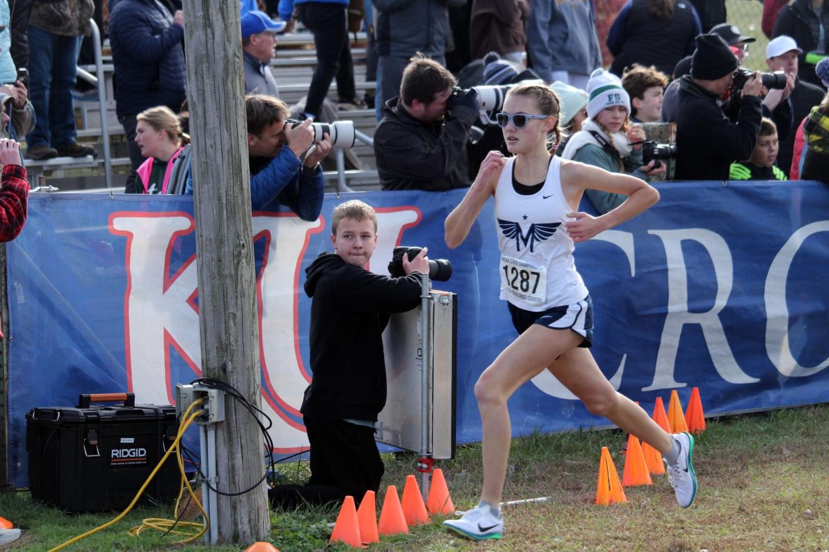 Go Isla. Freshman Isla Spreer gives it all she has as she crosses the finish line. Isla placed 9th at state helping to win state for the first time in 10 years.