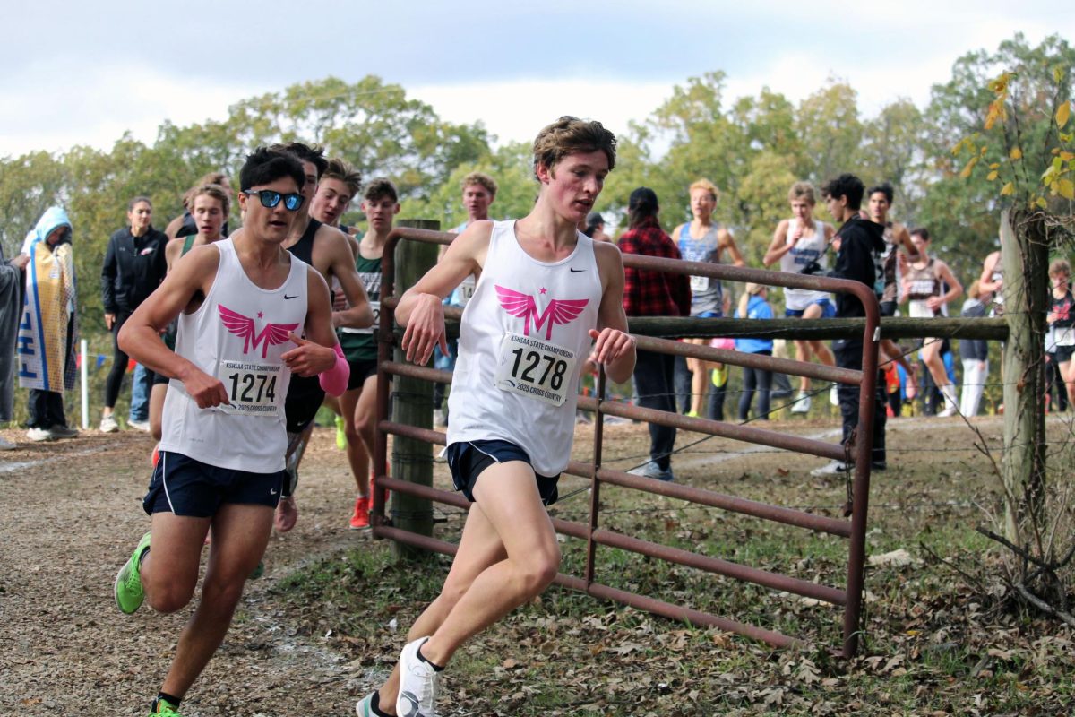 Go Manhattan! Wilson Wesch and Patrick Huser dash around the corner and down the hill. They both helped Manhattan get 8th place which is better than last year’s where they got 10th. 