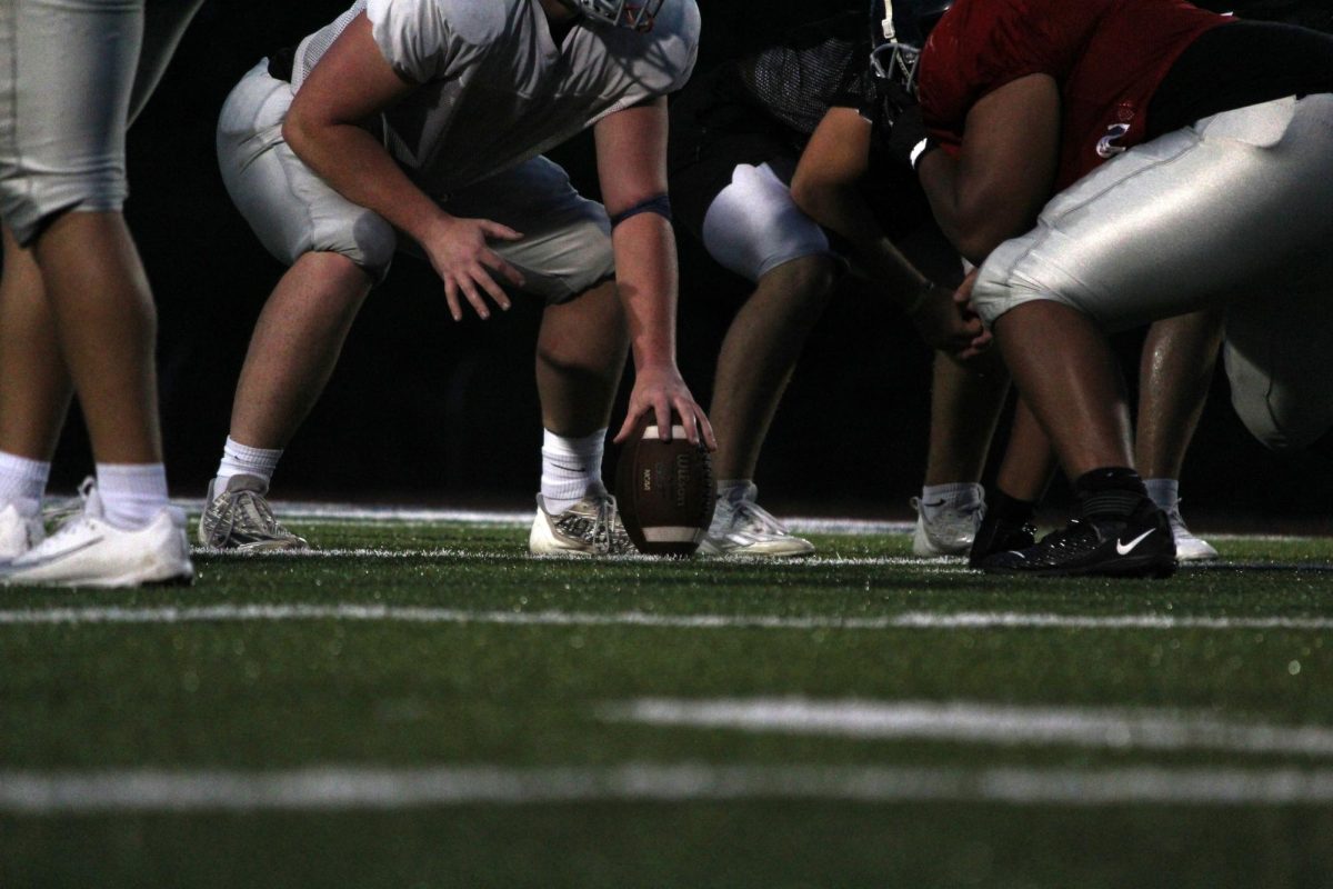 Set... the offensive line lines up for the next play to get lots of yards. 